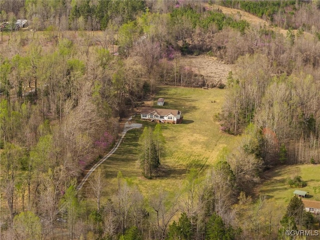 birds eye view of property featuring a view of trees