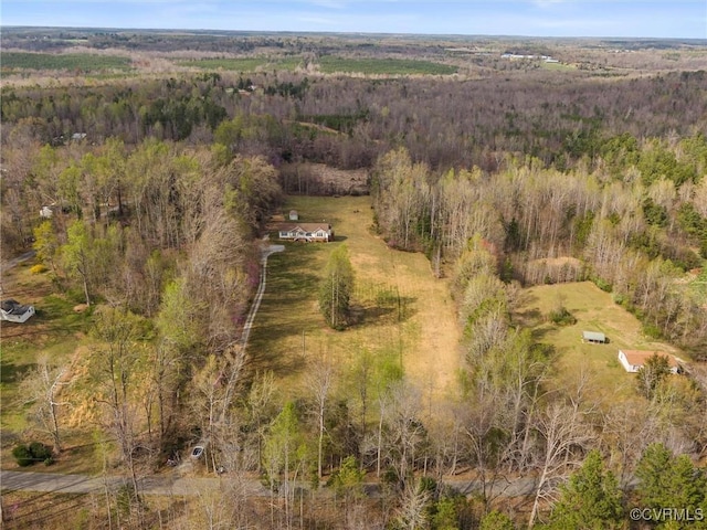 birds eye view of property with a view of trees
