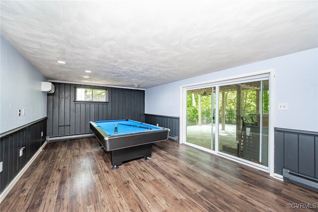 game room with wooden walls, a wainscoted wall, and an AC wall unit