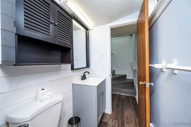 bathroom with toilet, wood finished floors, and vanity