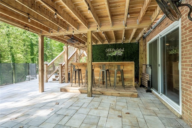 view of patio featuring outdoor dry bar and stairs