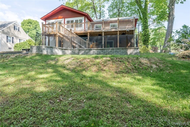 back of house featuring stairs, a lawn, and a deck