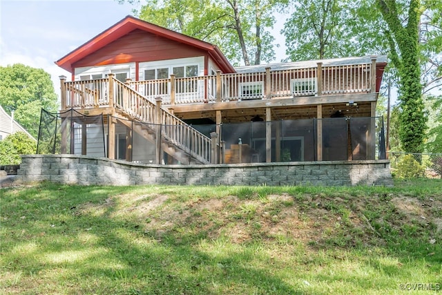 rear view of property with stairway, a deck, and a yard