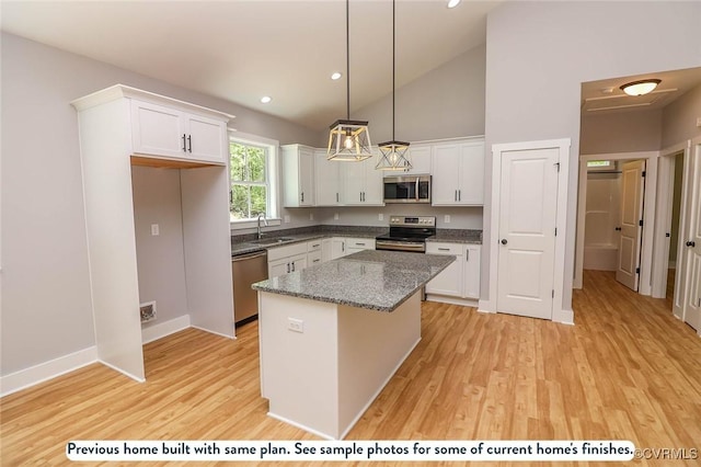 59 Jamestown Ln, Bracey, VA 23919 - kitchen featuring light wood-style floors, appliances with stainless steel finishes, a sink, white cabinetry, and a center island
