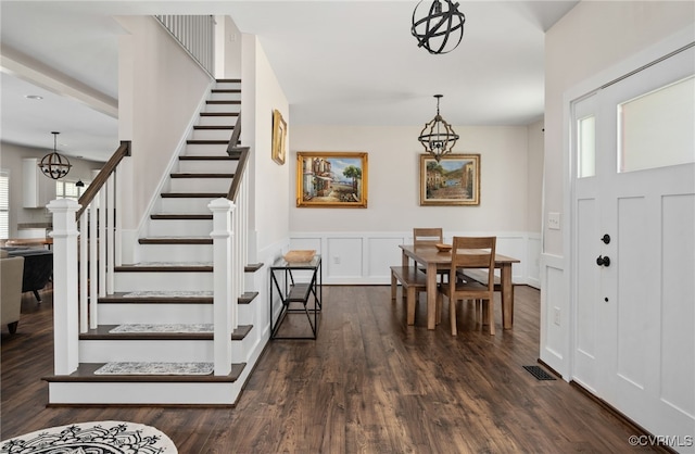 13201 Brooke Ridge Ln, Spotsylvania, VA 22551 - entryway featuring stairs, dark wood finished floors, wainscoting, a chandelier, and a decorative wall
