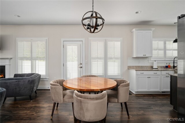 13201 Brooke Ridge Ln, Spotsylvania, VA 22551 - dining area featuring a warm lit fireplace, dark wood-style floors, and a chandelier