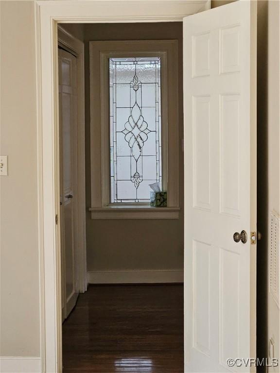 interior space with baseboards and dark wood finished floors