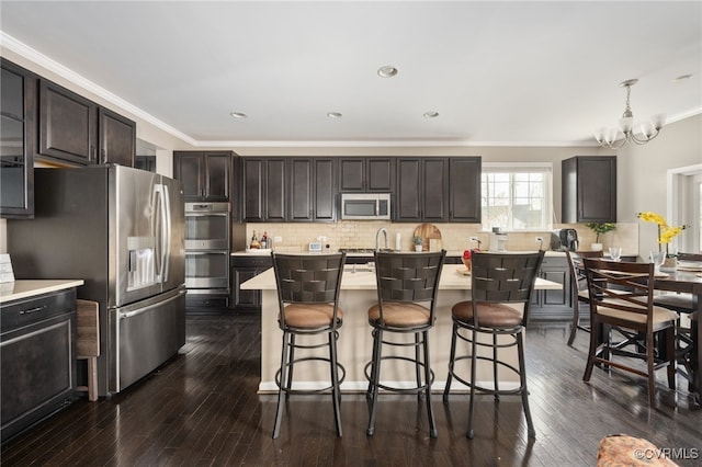 15 Elm St, Stafford, VA 22554 - kitchen with stainless steel appliances, light countertops, a kitchen breakfast bar, crown molding, and a chandelier