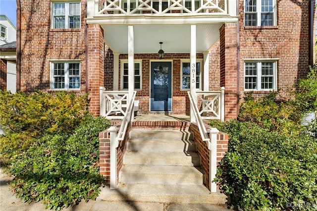 entrance to property featuring brick siding