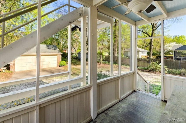 unfurnished sunroom featuring a ceiling fan