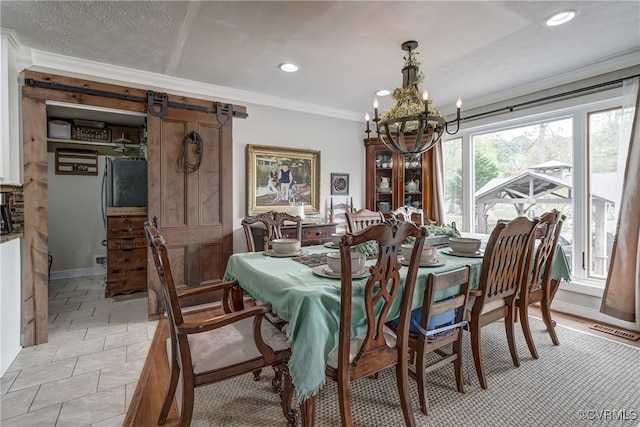dining space with a barn door, visible vents, recessed lighting, a chandelier, and crown molding