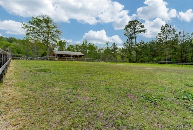 view of yard featuring fence and a rural view