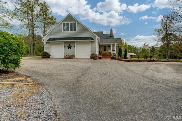 view of front of property with driveway and a chimney