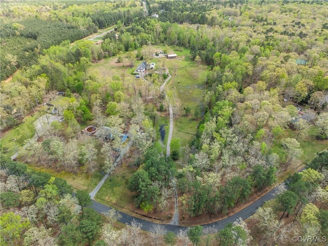 drone / aerial view featuring a view of trees