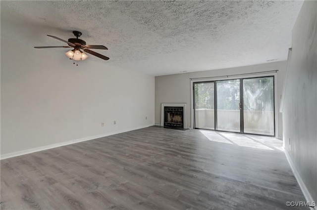 12255 Shore View Dr, Henrico, VA 23233 - unfurnished living room featuring a textured ceiling, a fireplace, wood finished floors, and a ceiling fan