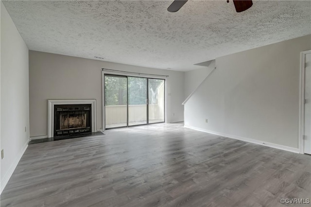 12255 Shore View Dr, Henrico, VA 23233 - unfurnished living room featuring ceiling fan, wood finished floors, a textured ceiling, and a fireplace with flush hearth