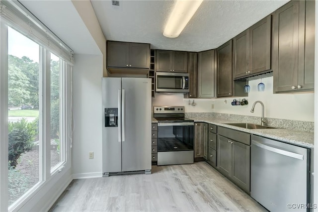 12255 Shore View Dr, Henrico, VA 23233 - kitchen featuring appliances with stainless steel finishes, light wood finished floors, open shelves, dark brown cabinets, and a textured ceiling