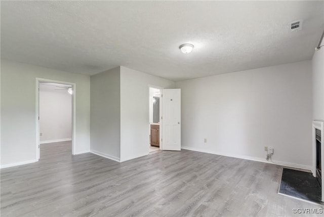 12255 Shore View Dr, Henrico, VA 23233 - unfurnished living room with light wood-style flooring and a textured ceiling