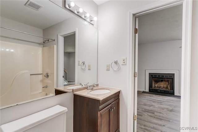 12255 Shore View Dr, Henrico, VA 23233 - full bath featuring vanity,  shower combination, wood finished floors, and a fireplace