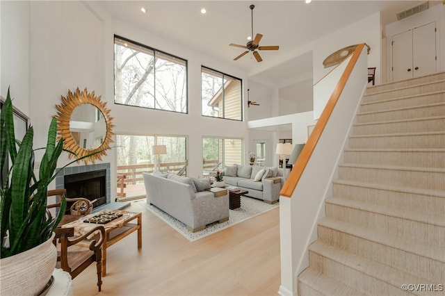 941 Wilton Coves Dr, Hartfield, VA 23071 - living room with a ceiling fan, recessed lighting, stairs, wood finished floors, and a tile fireplace