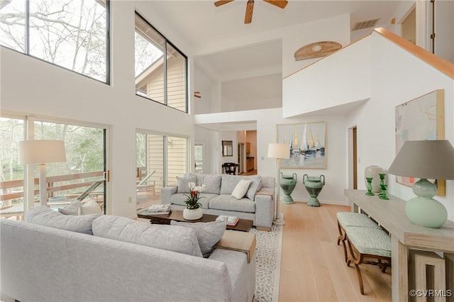 941 Wilton Coves Dr, Hartfield, VA 23071 - living room featuring a ceiling fan, wood finished floors, and a towering ceiling
