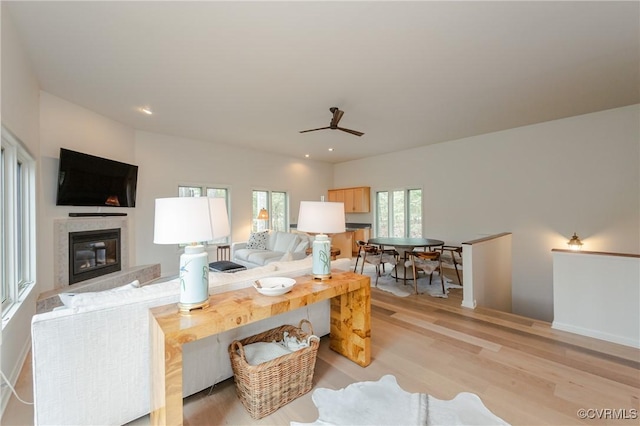941 Wilton Coves Dr, Hartfield, VA 23071 - living room with light wood-style floors, ceiling fan, a glass covered fireplace, and recessed lighting