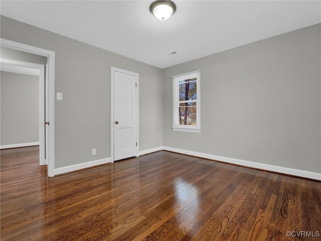 unfurnished bedroom featuring visible vents, baseboards, and wood finished floors