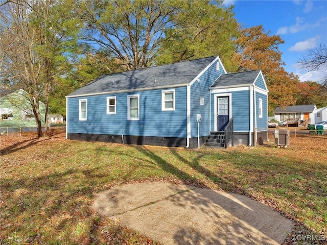 back of property featuring a lawn, crawl space, fence, and entry steps