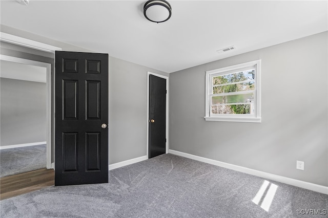 14008 Tyus Rd, Sussex, VA 23882 - unfurnished bedroom with carpet floors, visible vents, and baseboards