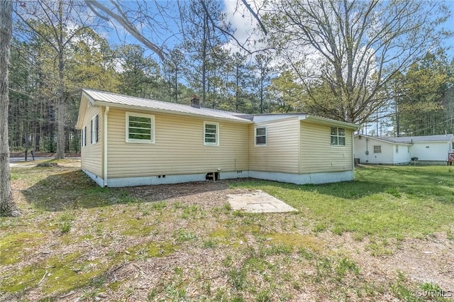 14008 Tyus Rd, Sussex, VA 23882 - back of house featuring a lawn, a chimney, and metal roof
