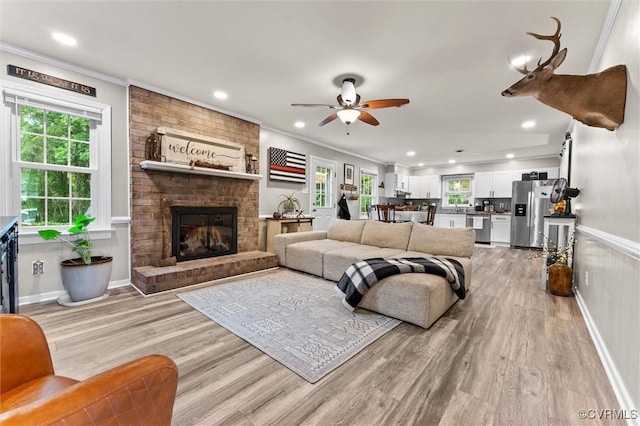 living room with recessed lighting, light wood finished floors, and ceiling fan