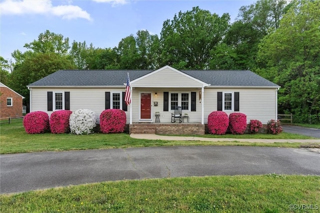 ranch-style home with a porch and a front lawn