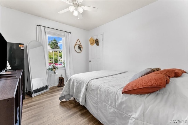 bedroom with ceiling fan and light wood-style floors