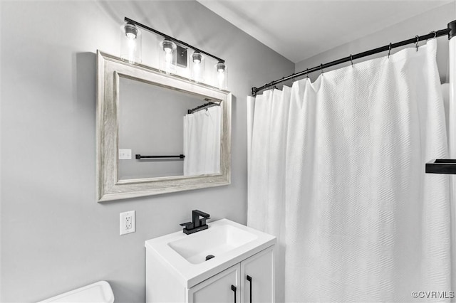 bathroom with toilet and vanity