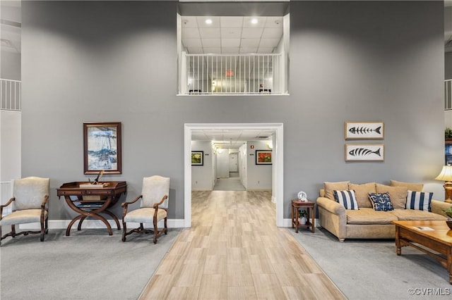 301 Beacon Ridge Dr Unit 109, Hopewell, VA 23860 - living area featuring a towering ceiling, wood finished floors, and recessed lighting