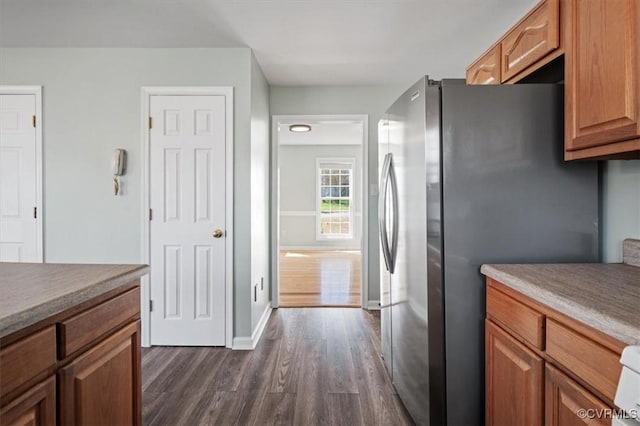2567 Exhall Ct, Chester, VA 23831 - kitchen with freestanding refrigerator, dark wood-style floors, baseboards, and brown cabinetry