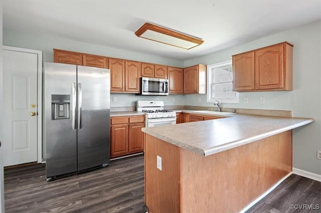 2567 Exhall Ct, Chester, VA 23831 - kitchen with appliances with stainless steel finishes, a sink, a peninsula, dark wood finished floors, and light countertops