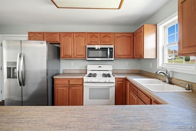 2567 Exhall Ct, Chester, VA 23831 - kitchen with stainless steel appliances, a sink, light countertops, and brown cabinets