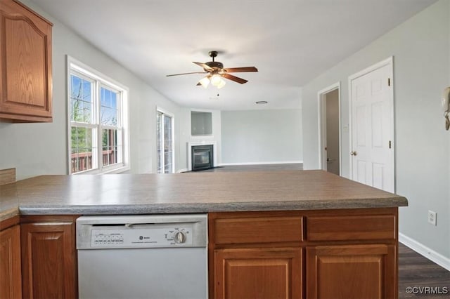 2567 Exhall Ct, Chester, VA 23831 - kitchen featuring white dishwasher, a glass covered fireplace, a ceiling fan, dark wood-style floors, and baseboards