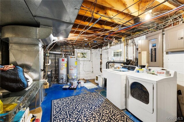 washroom with washing machine and clothes dryer, laundry area, and gas water heater