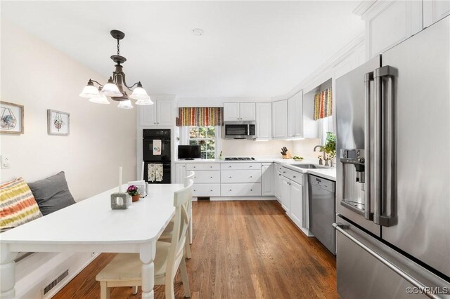 kitchen featuring a sink, visible vents, white cabinetry, light countertops, and appliances with stainless steel finishes