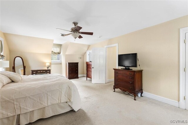 bedroom with vaulted ceiling, baseboards, ceiling fan, and light colored carpet