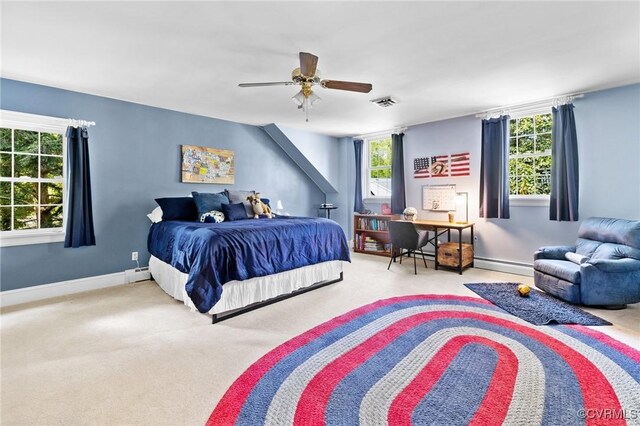carpeted bedroom with a baseboard radiator, a baseboard heating unit, ceiling fan, baseboards, and visible vents