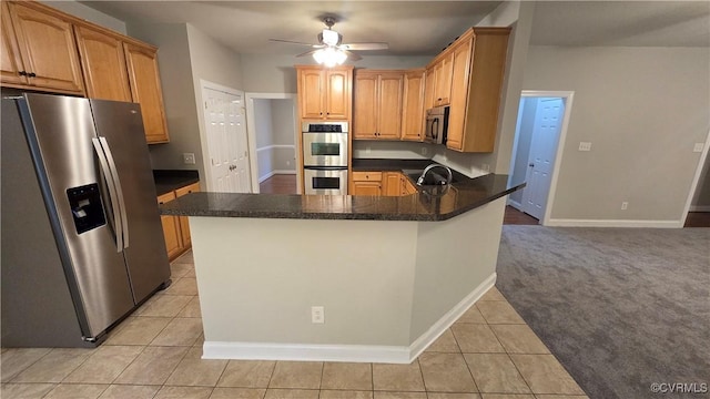 454 W Spring Forest Rd, King William, VA 23086 - kitchen with light tile patterned floors, baseboards, ceiling fan, a peninsula, and appliances with stainless steel finishes