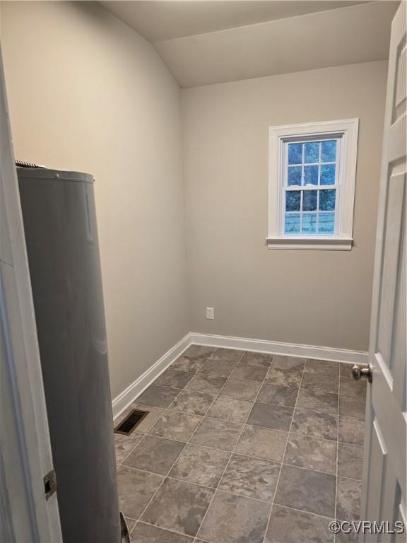 454 W Spring Forest Rd, King William, VA 23086 - spare room with lofted ceiling, baseboards, and visible vents