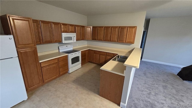 454 W Spring Forest Rd, King William, VA 23086 - kitchen with a peninsula, a sink, brown cabinetry, white appliances, and light countertops