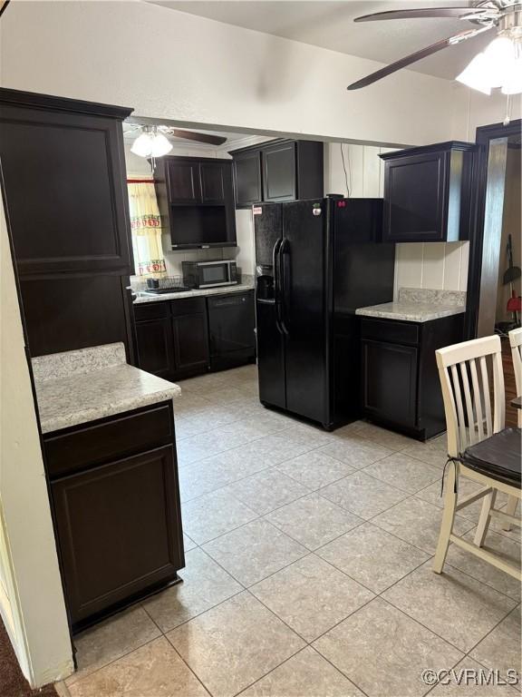 2919 Park Dr, Petersburg, VA 23805 - kitchen featuring ceiling fan, black fridge, stainless steel microwave, and light countertops