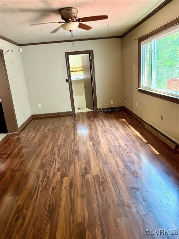 2919 Park Dr, Petersburg, VA 23805 - unfurnished bedroom featuring crown molding, dark wood-style flooring, a baseboard heating unit, and a ceiling fan