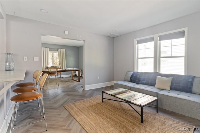 living area featuring baseboards