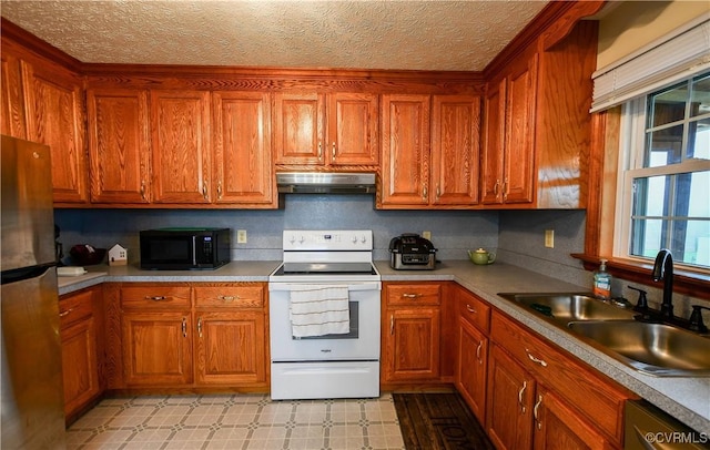 kitchen featuring extractor fan, brown cabinets, a sink, and stainless steel appliances